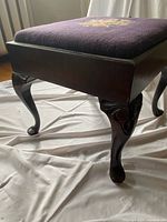 Side view showing cabriole leg and wood frame