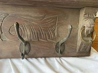 Close-up of central section showing carved pattern and two hooks