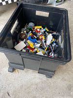 Top view of black wheeled tote filled with assorted LEGO pieces