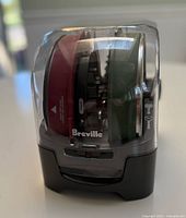 Complete kit in clear storage case showing Breville branding and stacked red and green discs