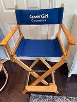 Front view of tall director chair showing logo, armrests and footrest