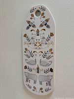 Front view of ceramic board showing full folk animal design