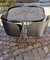 Table and four chairs assembled outdoors showing overall set