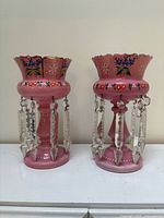 Front view of both lustre vases showing colour, decoration and prisms