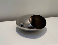 Perspective view of polished stainless steel bowl showing overall shape and opening