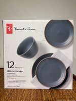 Front of sealed box showing brand, 12-piece denim stoneware set