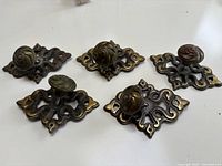 All five knobs with backplates displayed front view