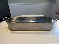 Side view of stainless steel fish poacher with lid on