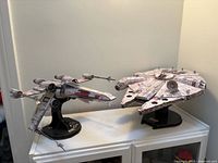 Both assembled Star Wars cardstock models on stands