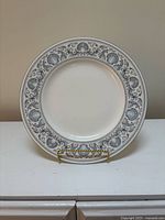 Front view of platter showing complete sea shell and dolphin border