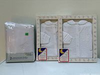 Overall view: two boxed pajamas and sealed pack of two blankets