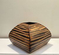 Front view of square tapered wooden vase showing striped natural and dark stain pattern