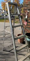 Full view of aluminum A-frame ladder, five rungs visible