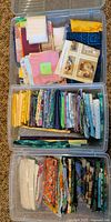 Top view of three clear plastic drawers filled with folded cotton fabric pieces