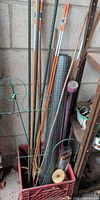 Assorted stakes, wire mesh roll, solar light, twine in red crate