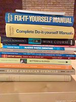 Stack showing 10 book spines including Reader's Digest manuals, Wine Course, woodworking and craft titles