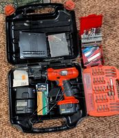 Entire kit inside carrying case with drill, charger, batteries, bit sets