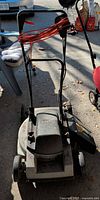 Full front view of Craftsman corded electric lawn mower showing handle, deck, and wrapped cord