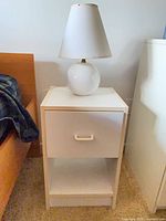 Nightstand with lamp showing overall design and wear