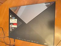 Top view of Sony BDP-S5200 showing stickers and power cord