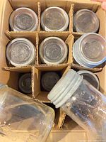 Top view of divided box showing pint jars, glass lids and metal rings