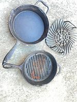 large cast iron skillet, smaller grill pan, separate cast iron grate