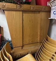Front view of solid wood communion table showing tapered panels and carved rosettes