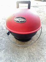 Front view of Kingsford red dome charcoal grill