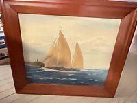 Full view of framed oil painting showing sailboat scene