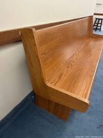 Close angled view of armrest and back rail