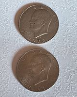 Obverse views of both Eisenhower dollar coins showing dates 1972 and 1776-1976