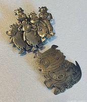 Front view of both brooches showing design details