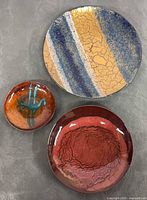 All three enamel dishes grouped showing colors and sizes