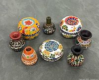 Group shot of three cloisonné boxes and four miniature Cuzco vases