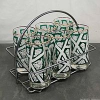 Six patterned glasses seated in chrome wire caddy