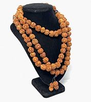 Mala necklace draped on display bust