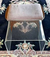 Wooden footrest and acrylic table shown together