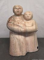 Front view of stone Inuit family sculpture