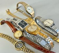 All six watches laid out showing faces and bands