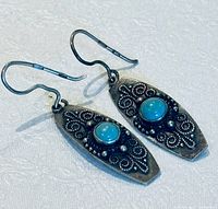 Front view of both earrings showing turquoise cabochons and filigree design