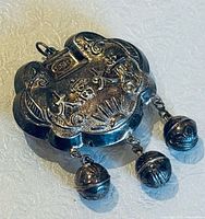 Front view of sterling silver Chinese lock pendant with rooster design and dangling bells