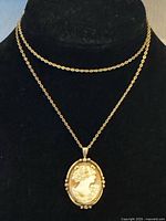 Necklace displayed on bust showing chain and pendant