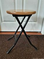 Full view of folded stool standing