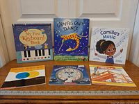 All six children’s books displayed upright and flat