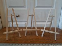Three wooden tabletop easels front view