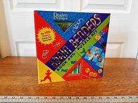 Front cover showing title, brand, and die-cut window displaying metal puzzle pieces