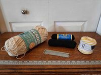 Full lot with large Bernat skein, two black skeins, Lily cake, crochet hooks
