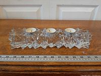 top view showing three tealights inserted in faceted crystal holder with ruler for scale