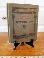 Front cover of geography textbook on stand