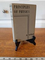 Front cover of grey hardcover textbook on stand